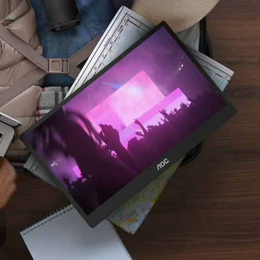 AOC business monitor viewed from above on a desk with notebooks and office items.