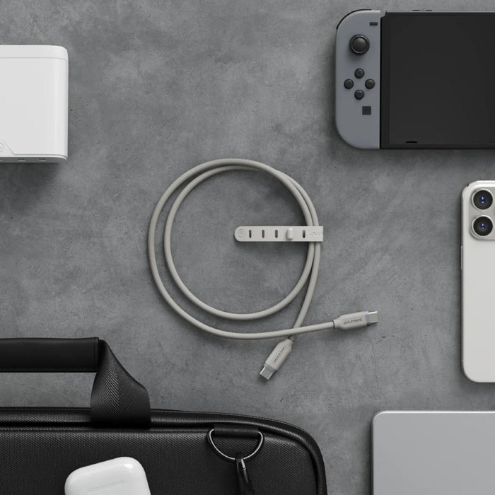 Collection of electronic devices and accessories on a gray surface