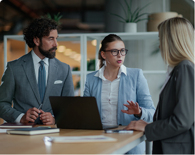 Two professionals in discussion at a laptop, symbolising verified ethical governance and transparent supply chains. Represents TechForGood’s B Corp Certification for independent ESG and procurement assurance.