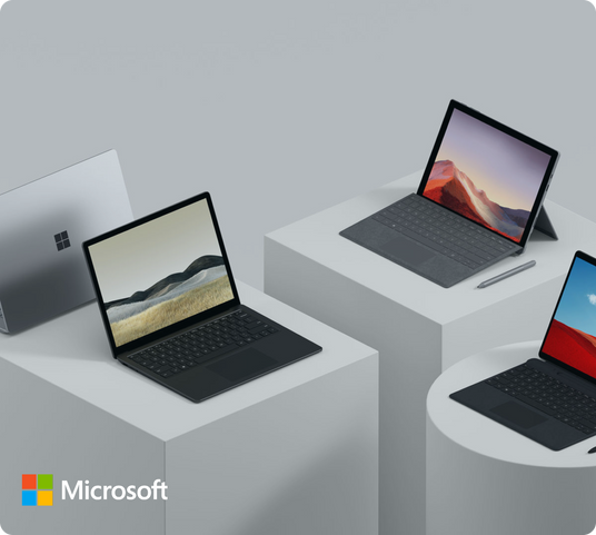 Range of Microsoft Surface devices including Laptop, Pro, and Go models displayed on raised platforms